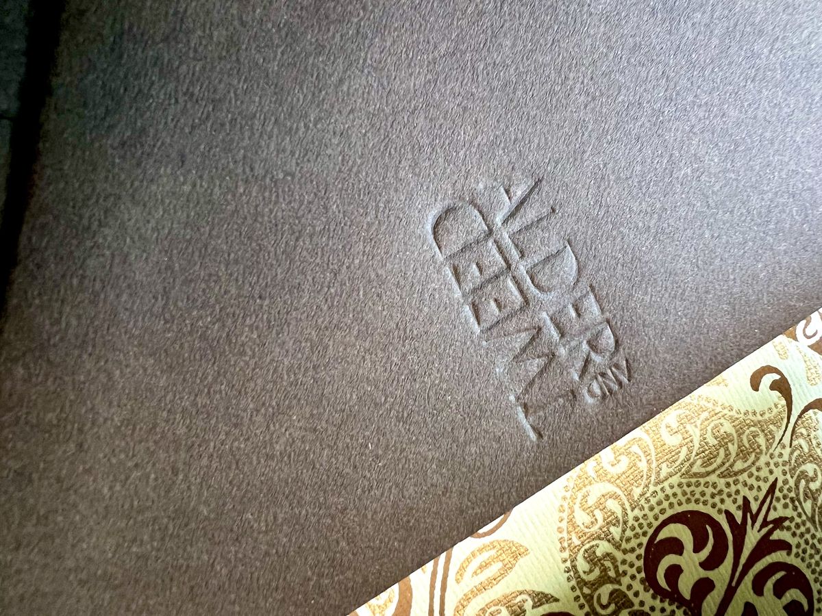 Blind debossed event invitation with a mountain motif and a dark brown envelope, image 5 of 6