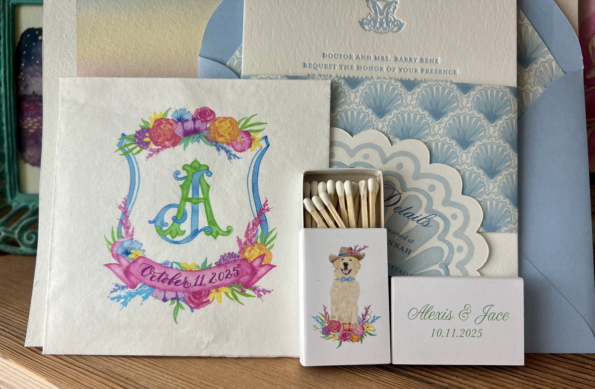 Day of stationery in soft blue with a hand-painted watercolor crest, scalloped details and custom matchboxes, image 1 of 3