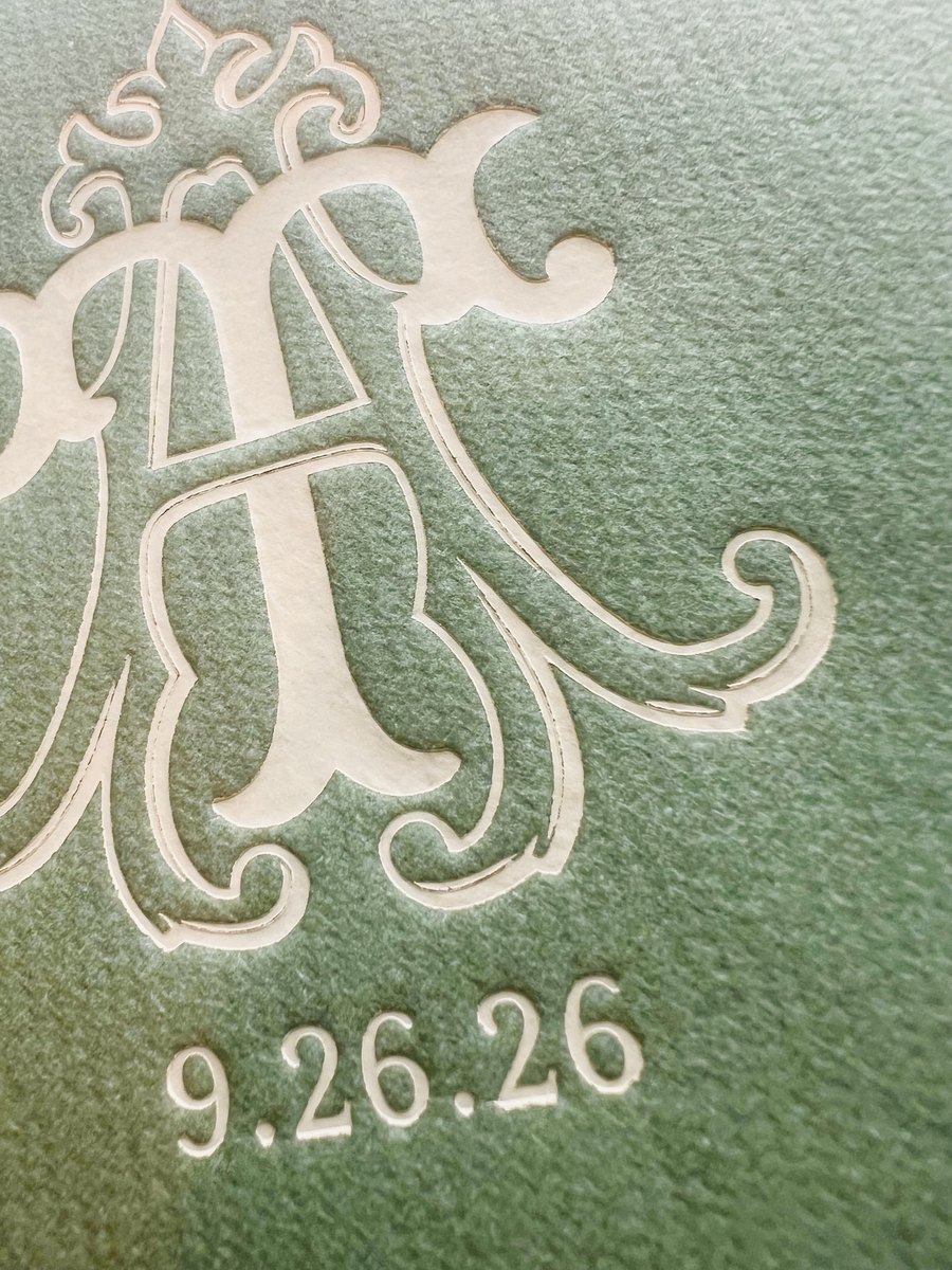 Blush letterpress monogram and wedding date printed on a sage green napkin